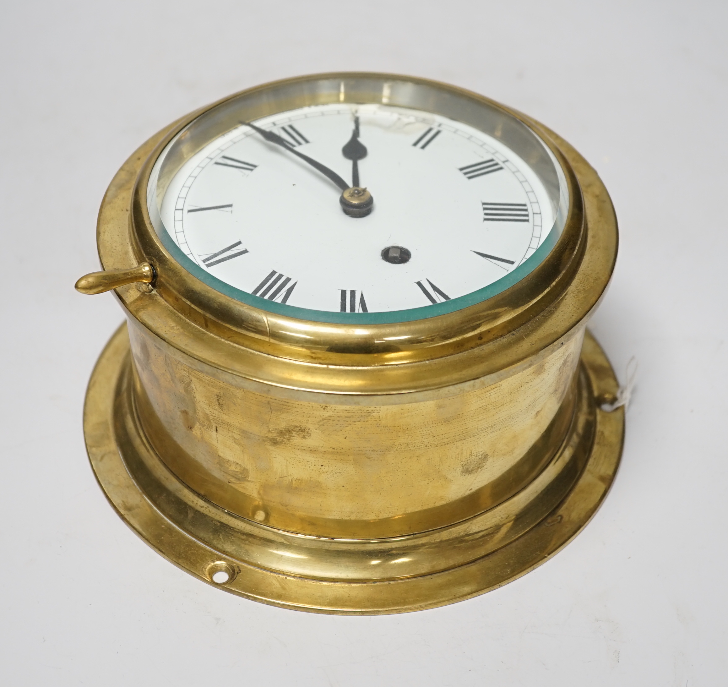 A brass ship’s bulkhead timepiece, 21cm diameter